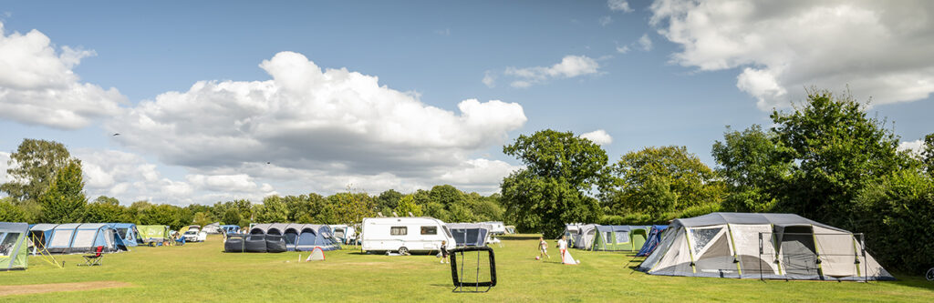 Family camping on a spacious grass pitch at South Lytchett Manor