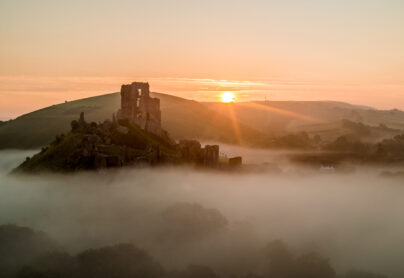 Misty Corfe Castle in Dorset at sunrise in the winter credit Richard Murgatroyd