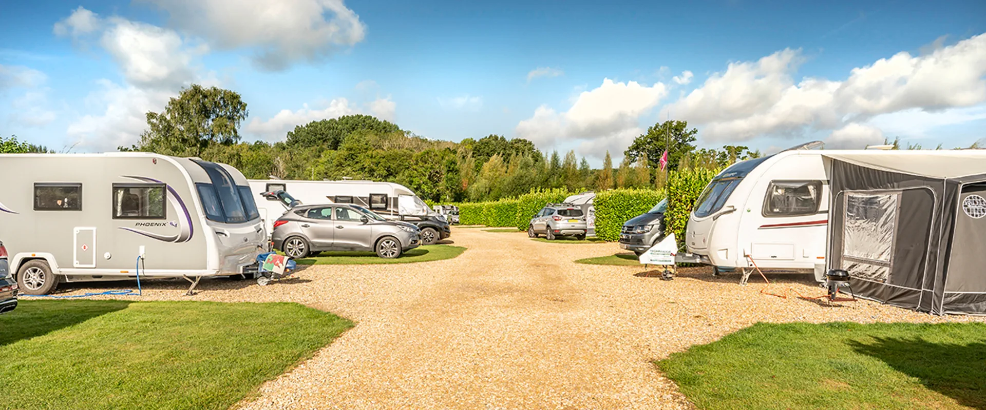Touring caravan pitch at award-winning South Lytchett Manor site near Poole Dorset