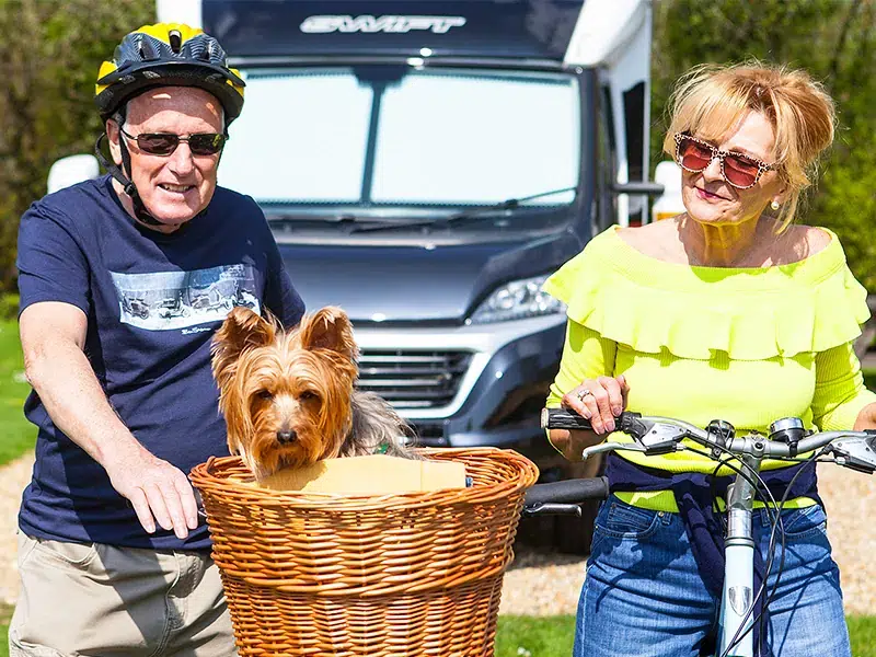 Couple relaxing at motorhome pitch South Lytchett Manor touring park Poole Dorset