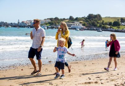 Family enjoying ice creams and a stroll along the beach